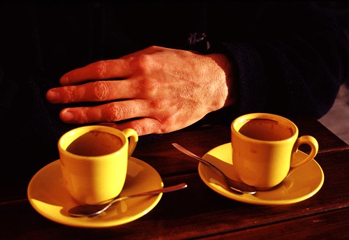 two coffee cups and hand